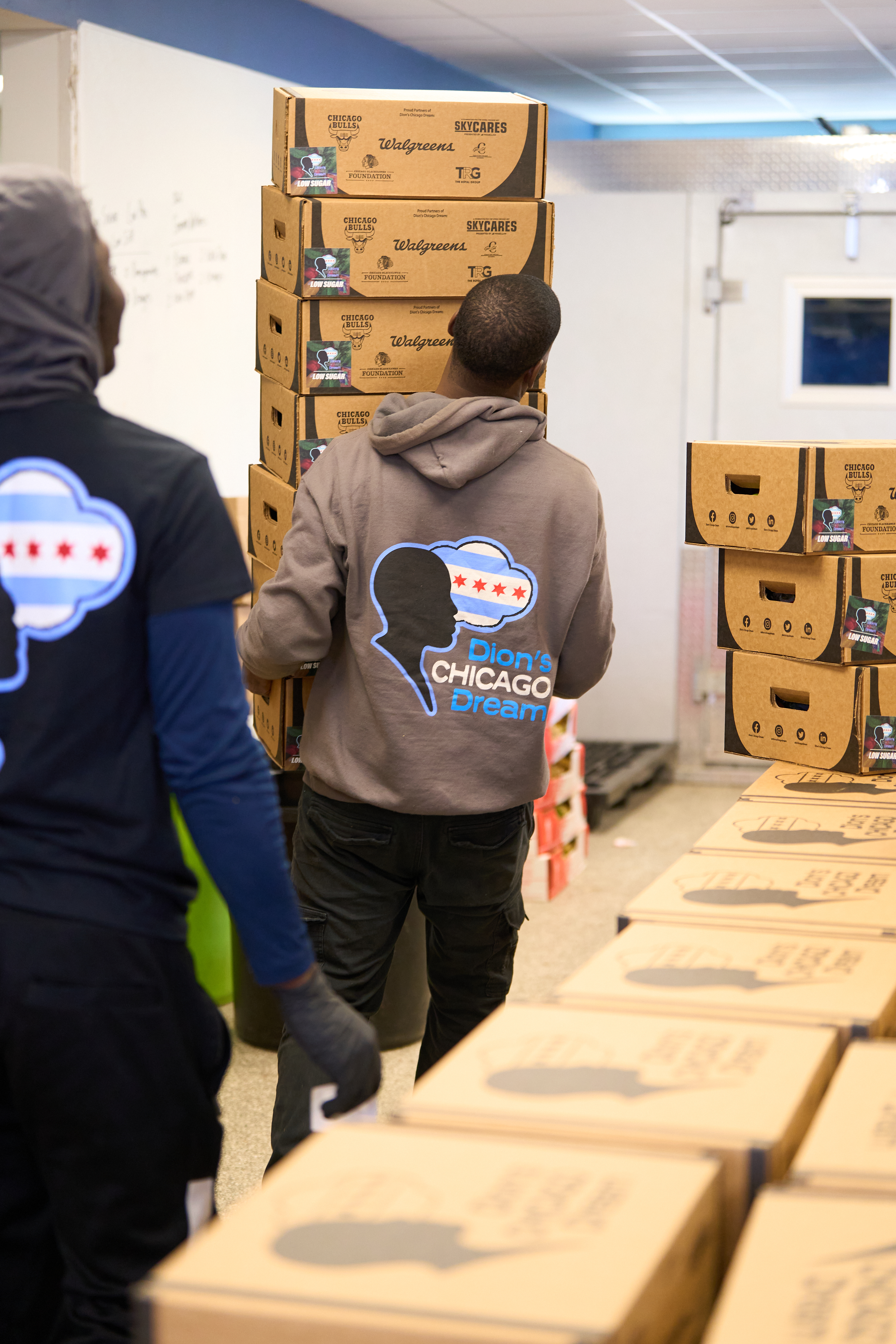 Dream Team members moving branded produce boxes